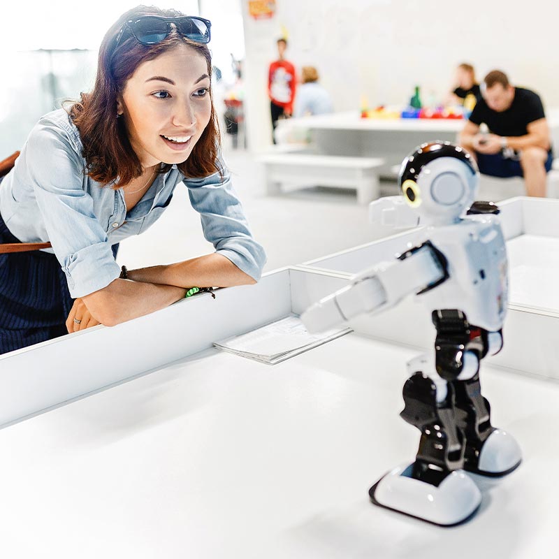 teacher looking at robot
