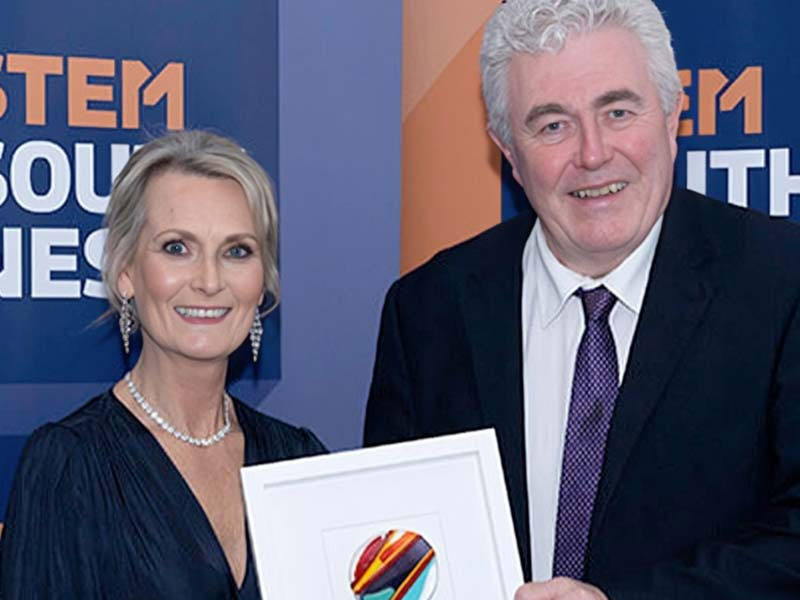 STEM South West award presentation with two people holding a framed certificate at the event