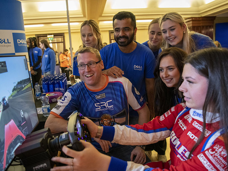 STEM South West participants trying a racing simulator with Dell Technologies team members.